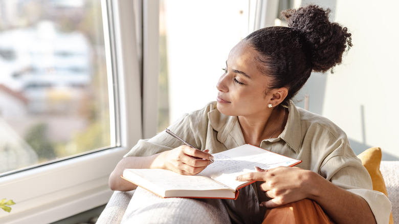 woman writing in journal