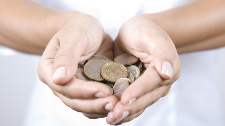 woman holding coins