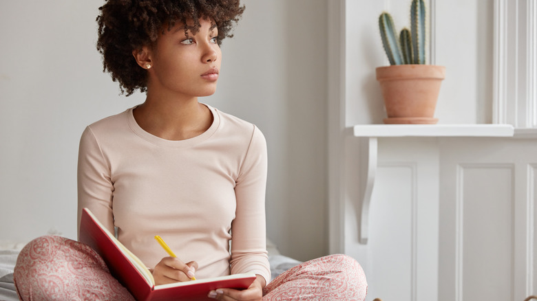 Woman writing in journal