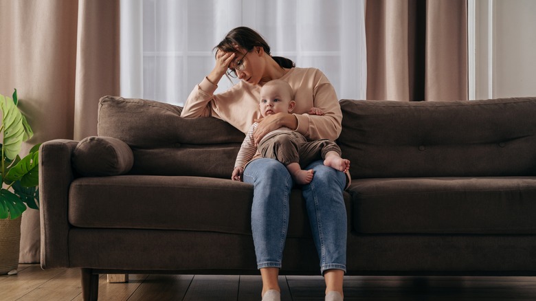 an exhausted single mother caring for her baby