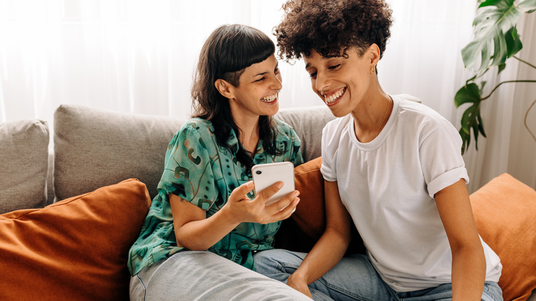 couple smiling at a phone