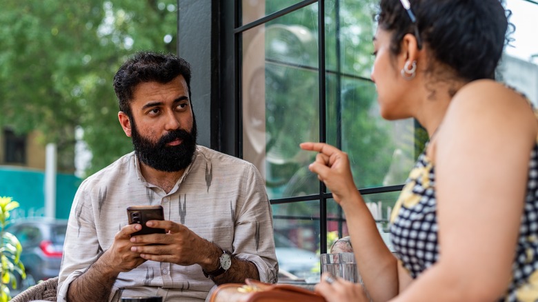 couple with a phone talking