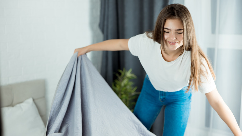 woman making bed 