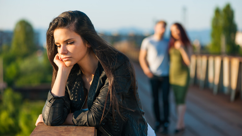 Woman feeling sad on bridge