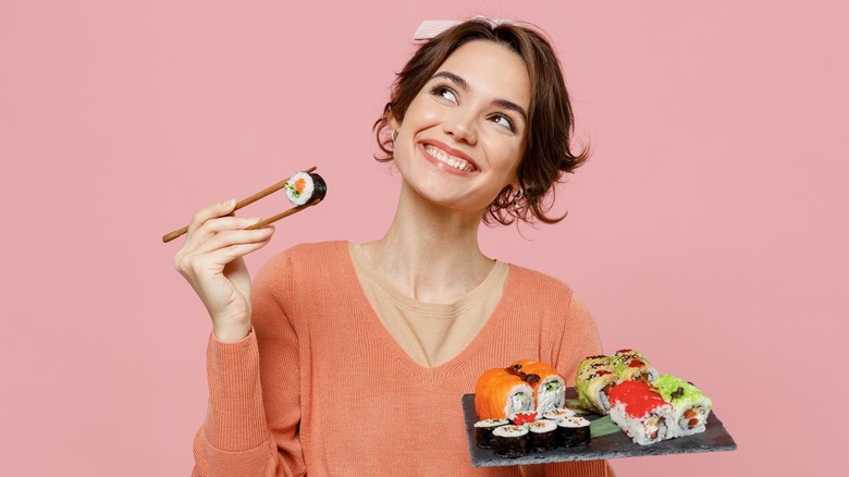Woman holding sushi