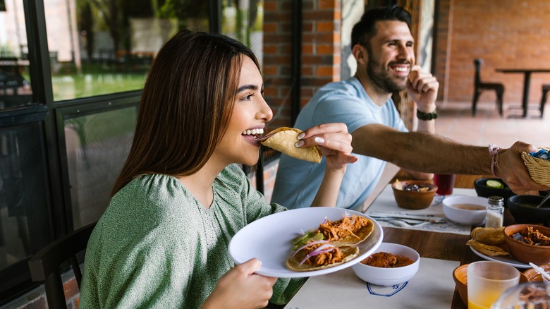 couple enjoying food with friends