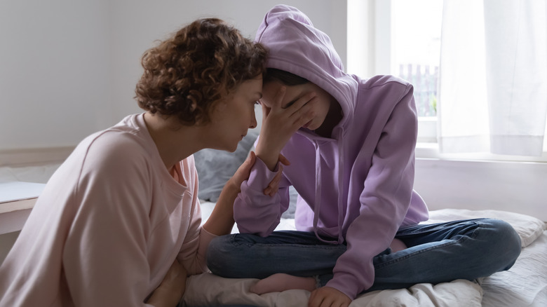 mother comforting daughter