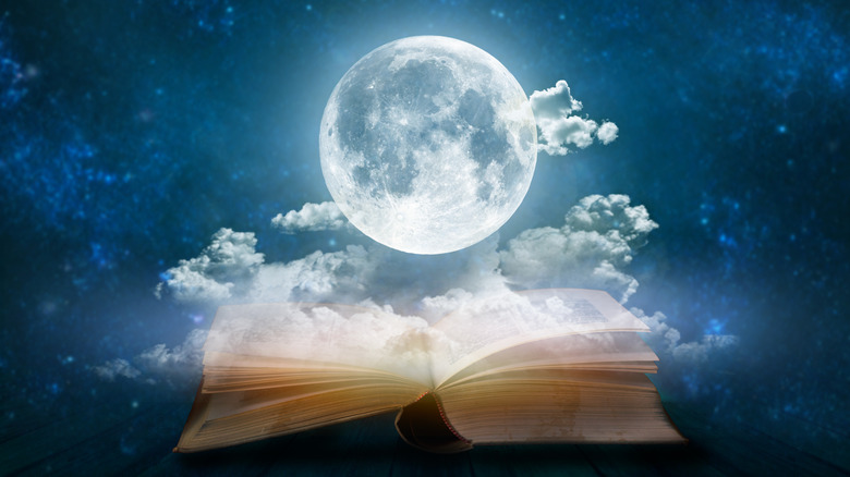 moon hovering over open book