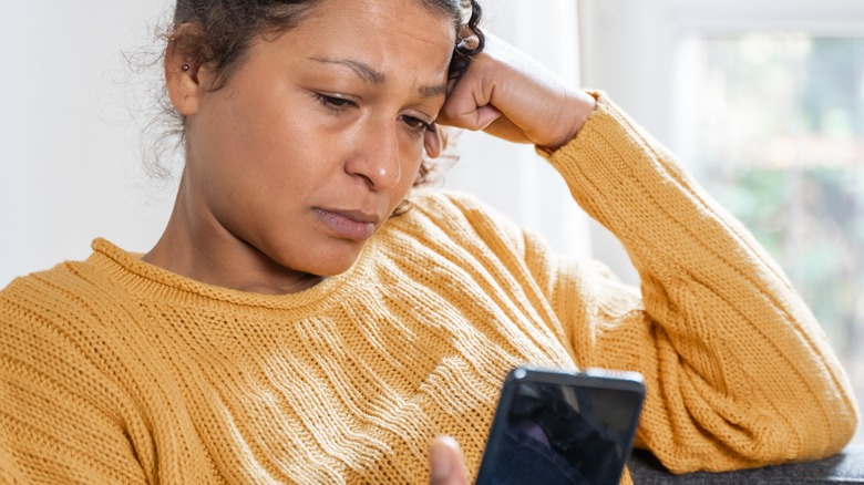 unhappy female checking her phone