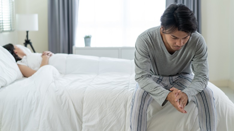 Two people arguing in bed