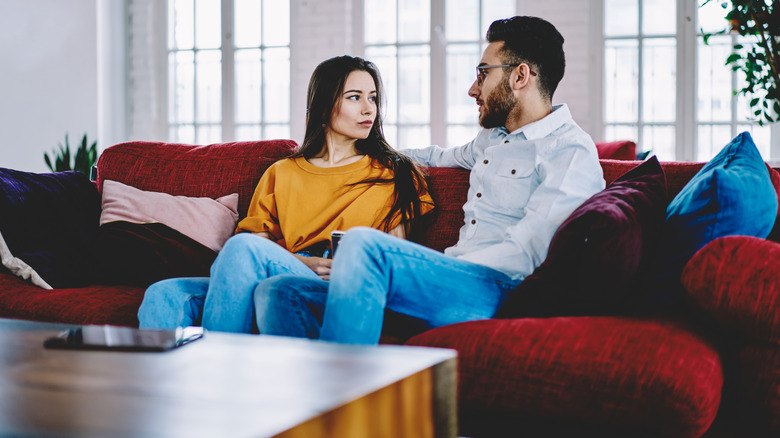 couple talking on sofa