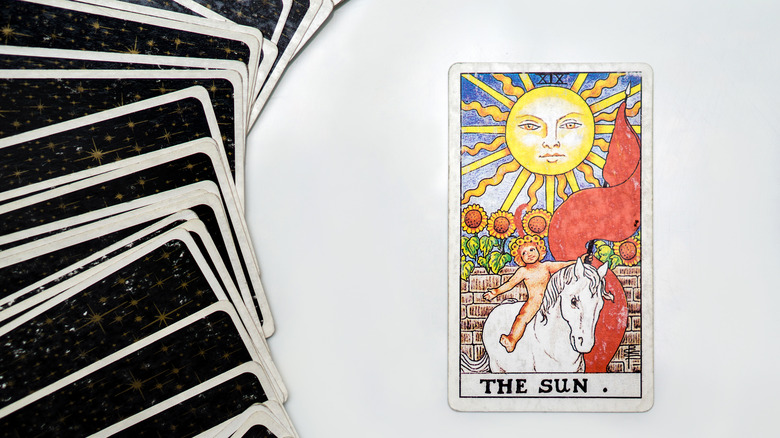 Sun tarot card on table