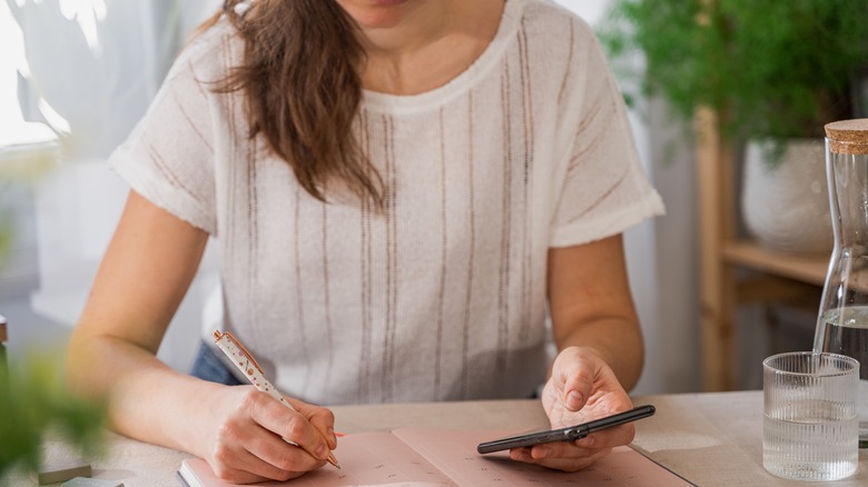 Woman marks calendar 