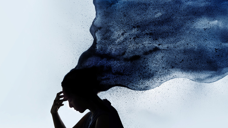 Woman with her thoughts represented by a dark cloud