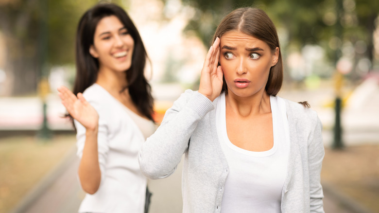 Woman trying to avoid someone in the street