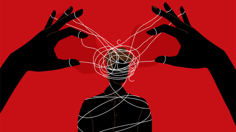 A visual of hands holding strings tied to a person's head