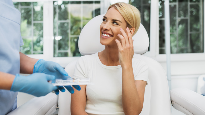 Woman sitting in plastic surgeon's office