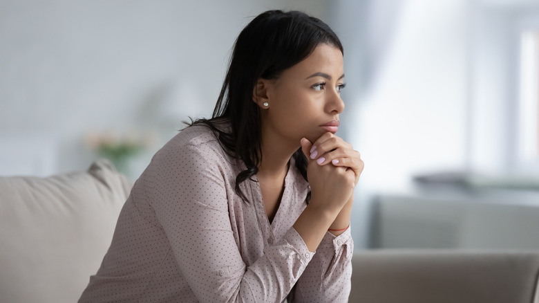 sad woman sitting on sofa