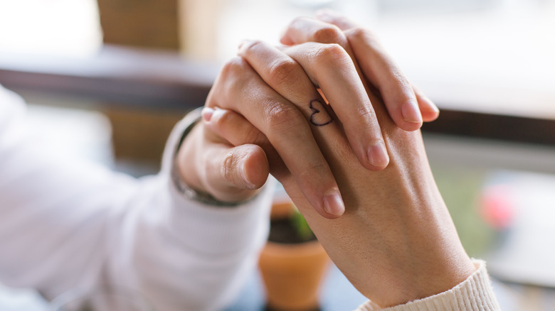 hand with heart tattoo