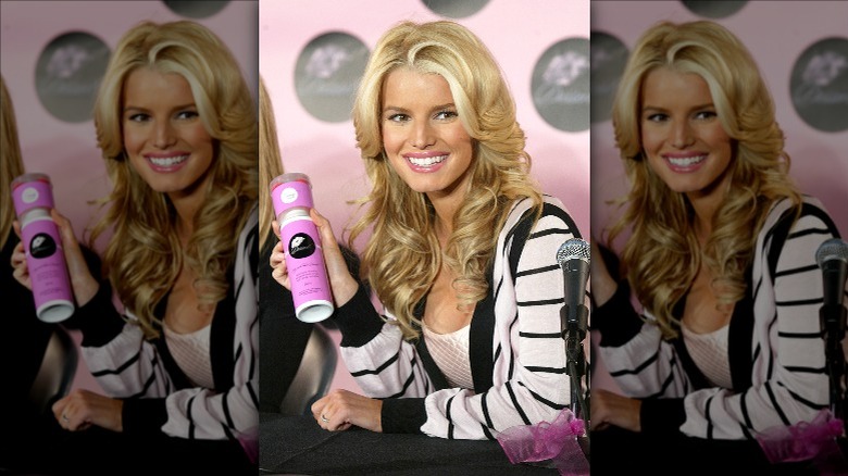 Jessica Simpson holding products