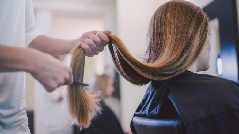 A woman getting her hair brushed