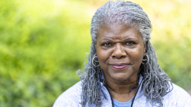 older woman smiling outdoors