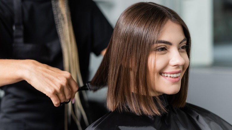 woman having her hair cut