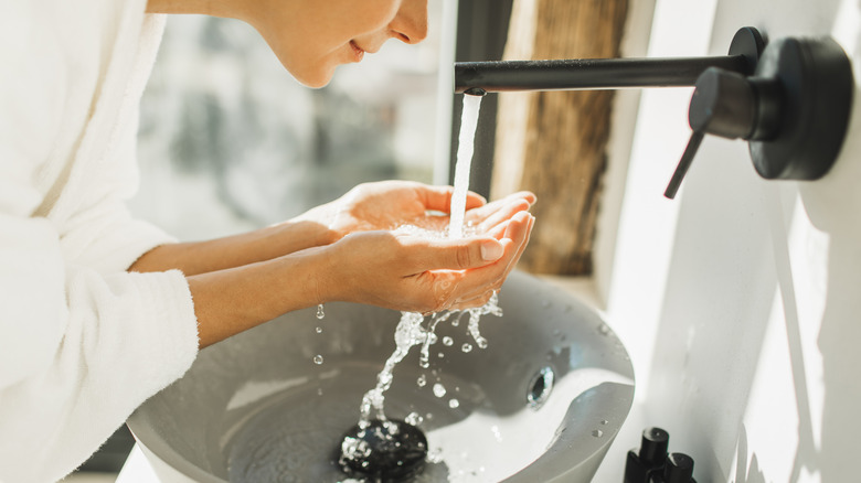 A woman washing her face