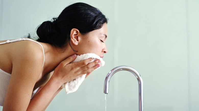 A woman washing her face