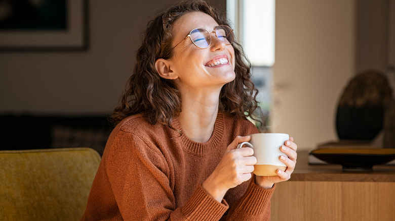 Woman smiling with cup of coffee