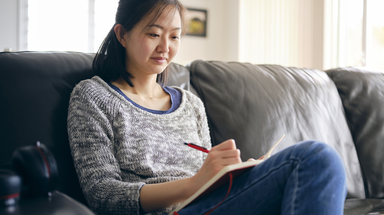 Woman writing in journal