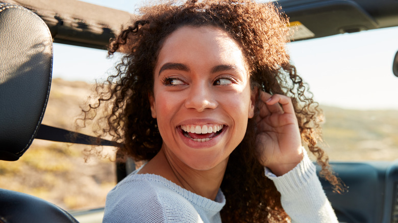 Smiling woman looking over her shoulder