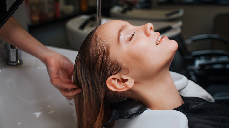 Woman at hair salon getting hair treatment