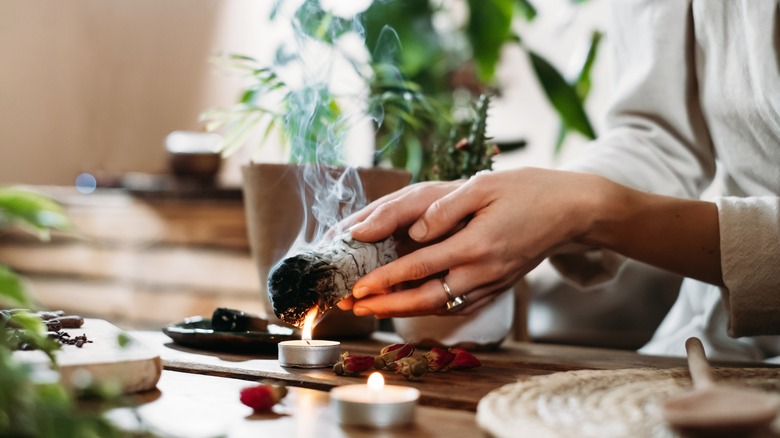 woman burning sage stick