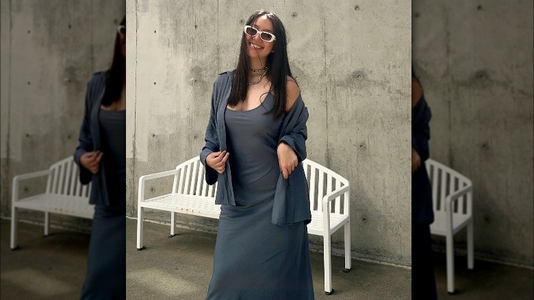 Woman poses in charcoal dress and matching overshirt 