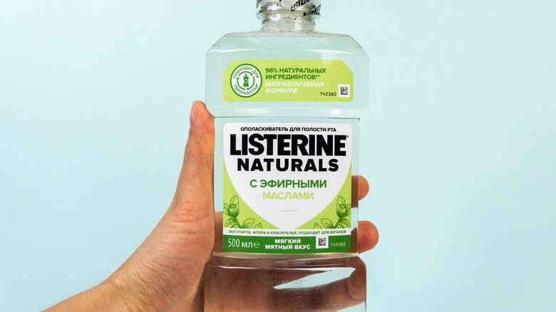 hand holding Listerine mouthwash