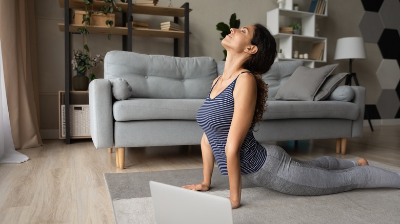 Woman doing yoga in home 