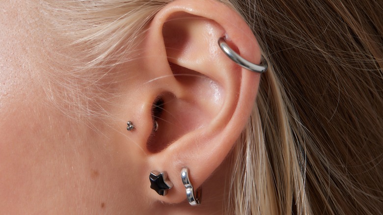 Ear with lobe, helix, and tragus piercings