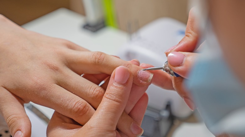 Person getting an e-file manicure