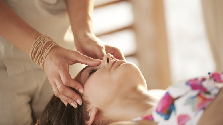 Esthetician using pressure points tapping