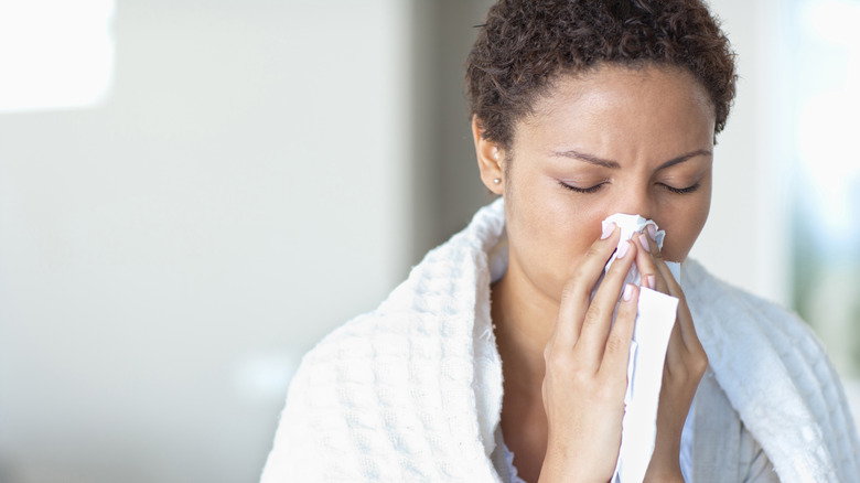 Woman blowing her nose