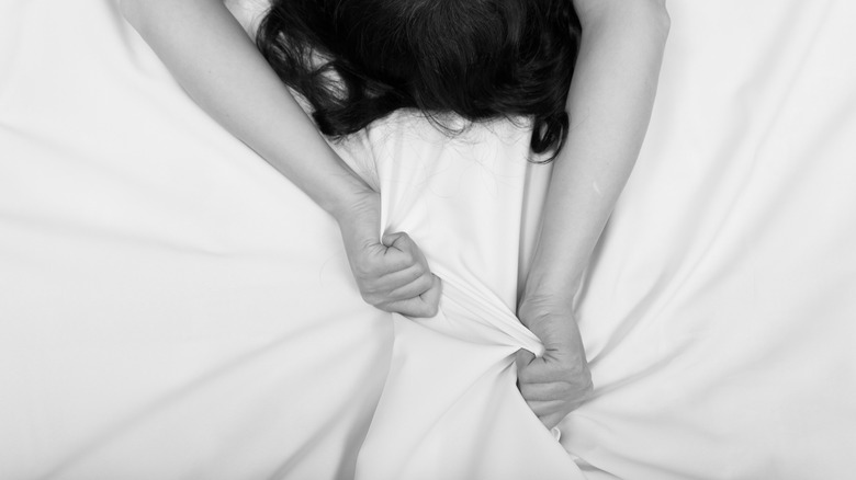 Woman grabbing sheets