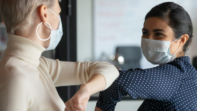 two masked female workers