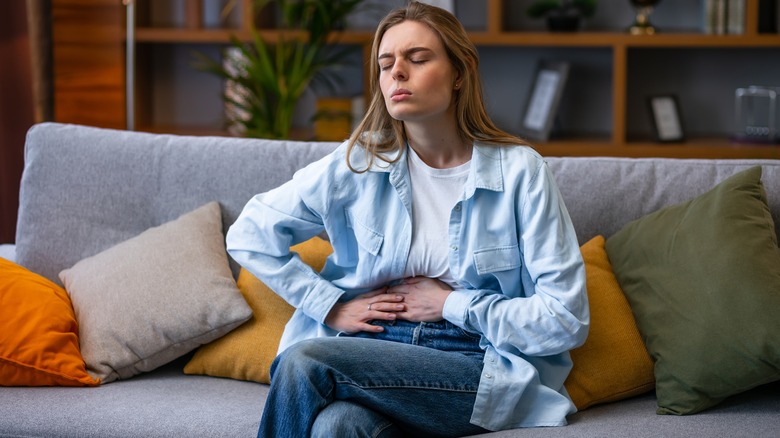 Woman placing hands on stomach