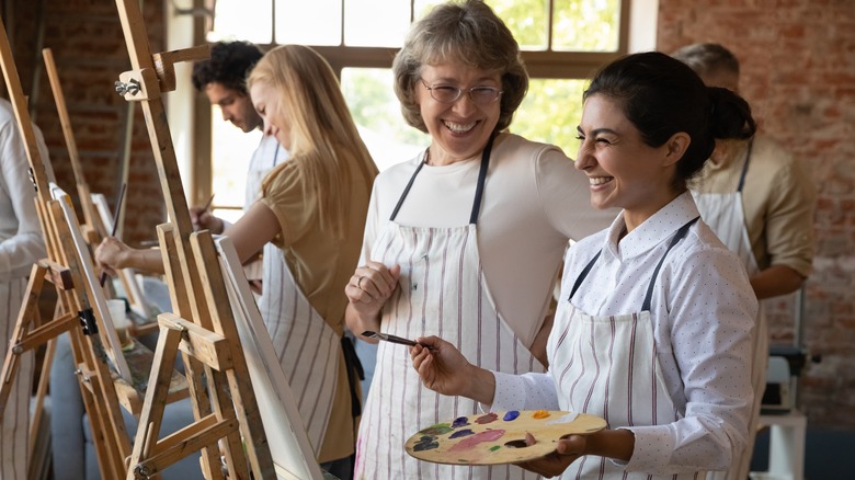 Women painting and smiling