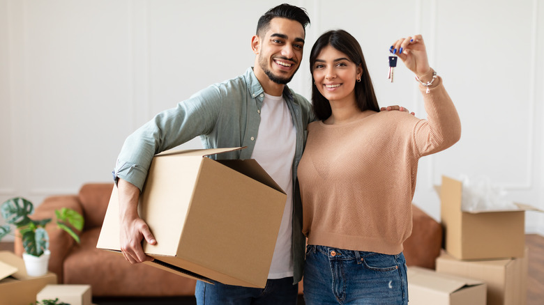 Couple smiling, moving boxes