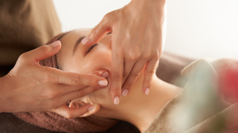 woman receiving professional face massage