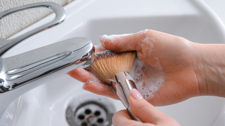 Woman cleaning makeup brush