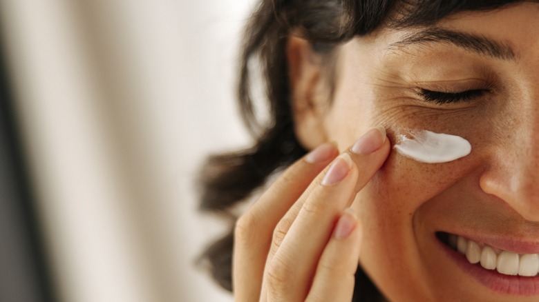 woman applying face cream 