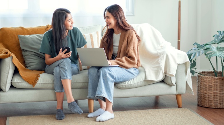 Two women talking on couch